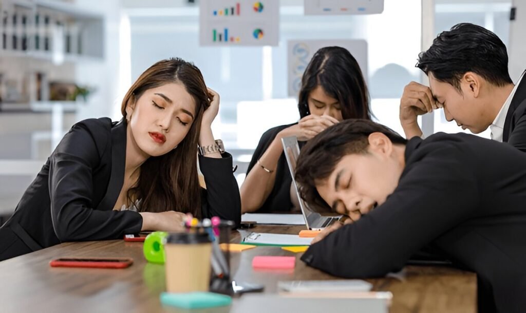 Your Team Isn’t Lazy—They’re Burned Out. Try TCM, Acupuncture and Breathwork Instead of a Broken Wellness Program 3 tired exhausted businesspeople sleeping after working late overtime
